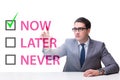 Concept of procrastination with now or later Royalty Free Stock Photo