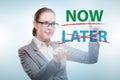 Concept of procrastination with now or later Royalty Free Stock Photo