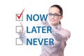 Concept of procrastination with now or later Royalty Free Stock Photo