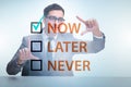 Concept of procrastination with now or later Royalty Free Stock Photo