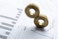 Concept of profit growth.Closeup of golden gears n the business graphs Royalty Free Stock Photo