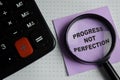 Concept of progress not perfection write on sticky notes isolated on Wooden Table Royalty Free Stock Photo