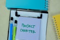 Concept of Project Charter write on sticky notes isolated on Wooden Table Royalty Free Stock Photo