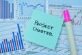 Concept of Project Charter write on sticky notes isolated on Wooden Table Royalty Free Stock Photo