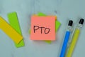 Concept of PTO write on sticky notes isolated on Wooden Table