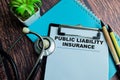 Concept of Public Liability Insurance write on paperwork with stethoscope isolated on wooden background Royalty Free Stock Photo