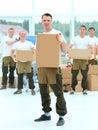 Foreman and workers with boxes of building materials