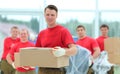 Foreman and workers with boxes of building materials