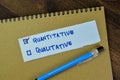 Concept of Quantitative and Qualitative write on sticky notes isolated on Wooden Table