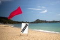 Concept quarantine, pandemic, coronavirus, travel ban. tropical beach on a sunny day without people. there is a red flag Royalty Free Stock Photo