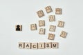 Concept of racism and misunderstanding between people, prejudice and discrimination. Wooden block with a white black figure
