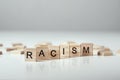 Concept of racism and misunderstanding between people, prejudice and discrimination. Wooden block with word racism on the white