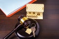 Concept of real estate auction, legal system and division of property after divorce. Gavel and house key on a wooden background Royalty Free Stock Photo