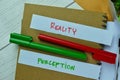 Concept of Reality or Perception write on sticky notes isolated on Wooden Table Royalty Free Stock Photo