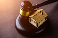 Concept of realty and law. Little wooden house and judges gavel Royalty Free Stock Photo
