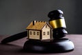 Concept of realty and law. Little wooden house and judges gavel Royalty Free Stock Photo