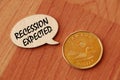 Concept of Recession expected write on wooden sign isolated on Wooden Table. Royalty Free Stock Photo