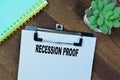 Concept of Recession Proof write on paperwork isolated on Wooden Table