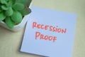 Concept of Recession Proof write on sticky notes isolated on Wooden Table Royalty Free Stock Photo