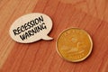 Concept of Recession warning write on wooden sign isolated on Wooden Table. Royalty Free Stock Photo