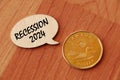Concept of Recession 2024 write on wooden sign isolated on Wooden Table. Royalty Free Stock Photo
