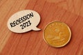 Concept of Recession 2023 write on wooden sign isolated on Wooden Table.