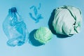 The concept recycling plastic. Empty plastic bottle and recycled polyester fiber, synthetic fabric blue background Royalty Free Stock Photo