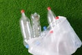 The concept of recycling plastic and environmental protection. Pet preforms for plastic bottles on the green grass. Artificial