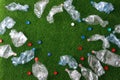 The concept of recycling plastic and environmental protection. Pet preforms for plastic bottles on the green grass. Artificial