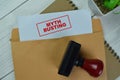 Concept of Red Handle Rubber Stamper and Myth Busting text above Brown envelope isolated on on Wooden Table Royalty Free Stock Photo