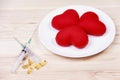 Concept red heart on plate with syringe and stimulant on wood b