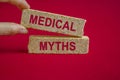 Concept red words Medical Myths on brick blocks. Beautiful red background. Medical and Medical Myths concept. Royalty Free Stock Photo