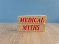 Concept red words Medical Myths on brick blocks. Beautiful wooden table blue background. Medical and Medical Myths concept. Copy Royalty Free Stock Photo