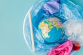 The concept of reducing plastic bags use: Modeled globes are sunk in many white plastic bags. Meaning, plastic bags are about to Royalty Free Stock Photo