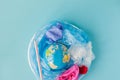 The concept of reducing plastic bags use: Modeled globes are sunk in many white plastic bags. Meaning, plastic bags are about to Royalty Free Stock Photo