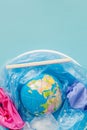 The concept of reducing plastic bags use: Modeled globes are sunk in many white plastic bags. Meaning, plastic bags are about to Royalty Free Stock Photo