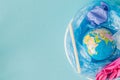 The concept of reducing plastic bags use: Modeled globes are sunk in many white plastic bags. Meaning, plastic bags are about to Royalty Free Stock Photo