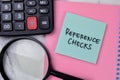 Concept of Reference Checks write on sticky notes isolated on Wooden Table