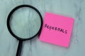 Concept of Referrals write on sticky notes isolated on Wooden Table Royalty Free Stock Photo