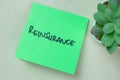 Concept of Reinsurance write on sticky notes isolated on Wooden Table