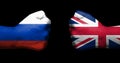 Concept of relations between Russia and the United Kingdom symbolized by two opposed clenched fists