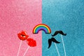 Concept of relationships between same-sex men and women, flatlay false photo stand props mustache and lips rainbow on a blue pink