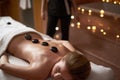 Lady have relieving massage with warm stones Royalty Free Stock Photo
