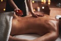 Massage therapist pour essential oil out from bowl Royalty Free Stock Photo