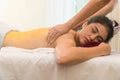 Concept relaxation and health spa.Beautiful Asian woman receiving salt with massage hand in spa salon Royalty Free Stock Photo