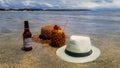 Concept of relaxing showing hats, pineapple juice with straw and abudweiser Royalty Free Stock Photo
