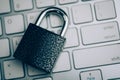 Concept of reliable protection. The lock on the white keyboard. Toned Royalty Free Stock Photo