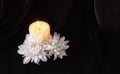 The concept of remembrance, funerals, and condolences. Candle and white flowers, free space for text Royalty Free Stock Photo
