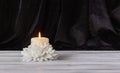 The concept of remembrance, funerals, and condolences. Candle and white flowers, free space for text Royalty Free Stock Photo