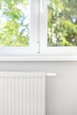 White metal heating radiator under plastic window Royalty Free Stock Photo